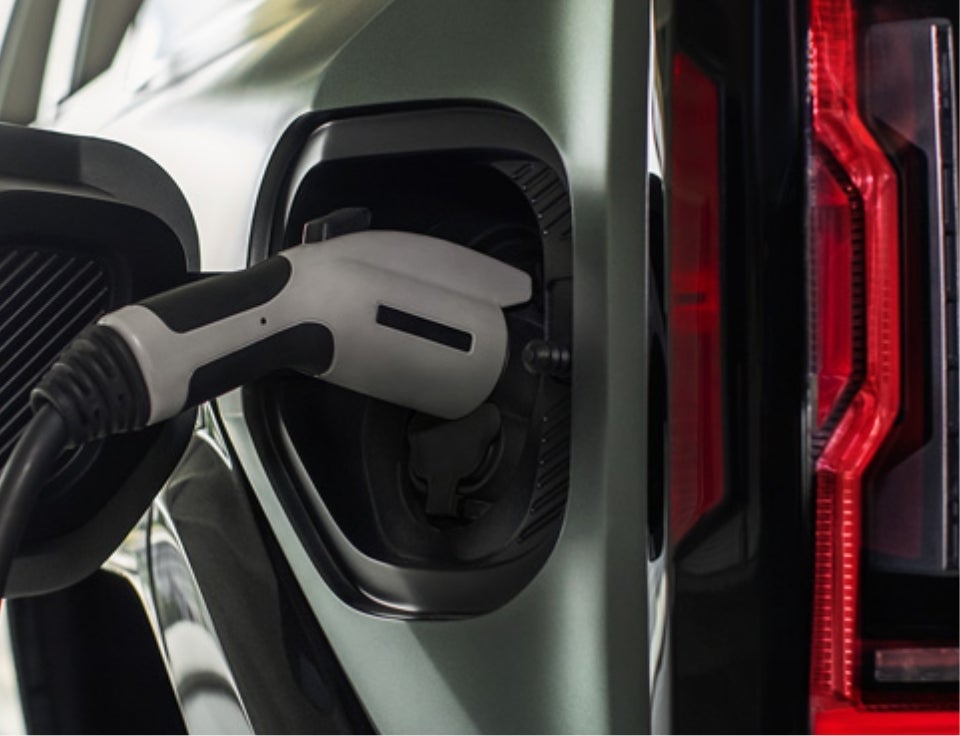 Close up of charging port with charger plugged in on a GMC Hummer EV SUV - Gerald Jones GMC in Graniteville SC